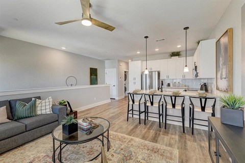 a living area with a kitchen and a dining table